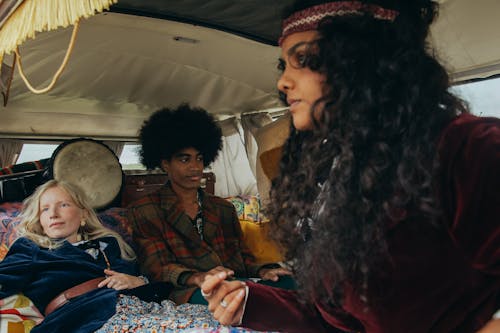Free Young Hippies Sitting in a Vintage Van  Stock Photo