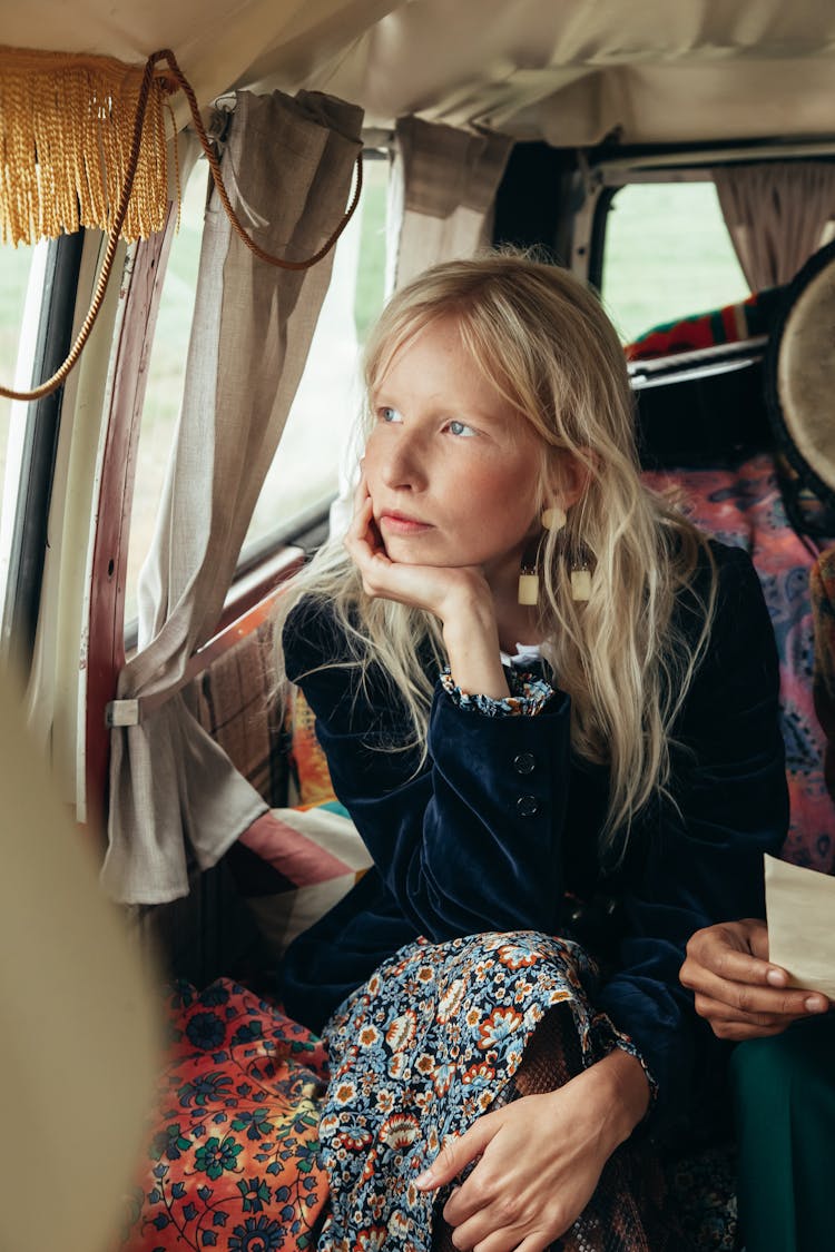 Woman Sitting By A Car Window And Daydreaming