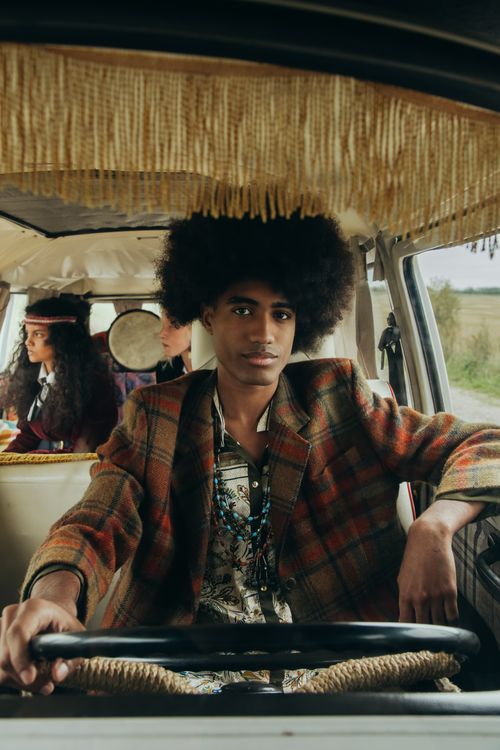 Free Portrait of a stylish man driving a retro van with friends on a countryside road trip. Stock Photo
