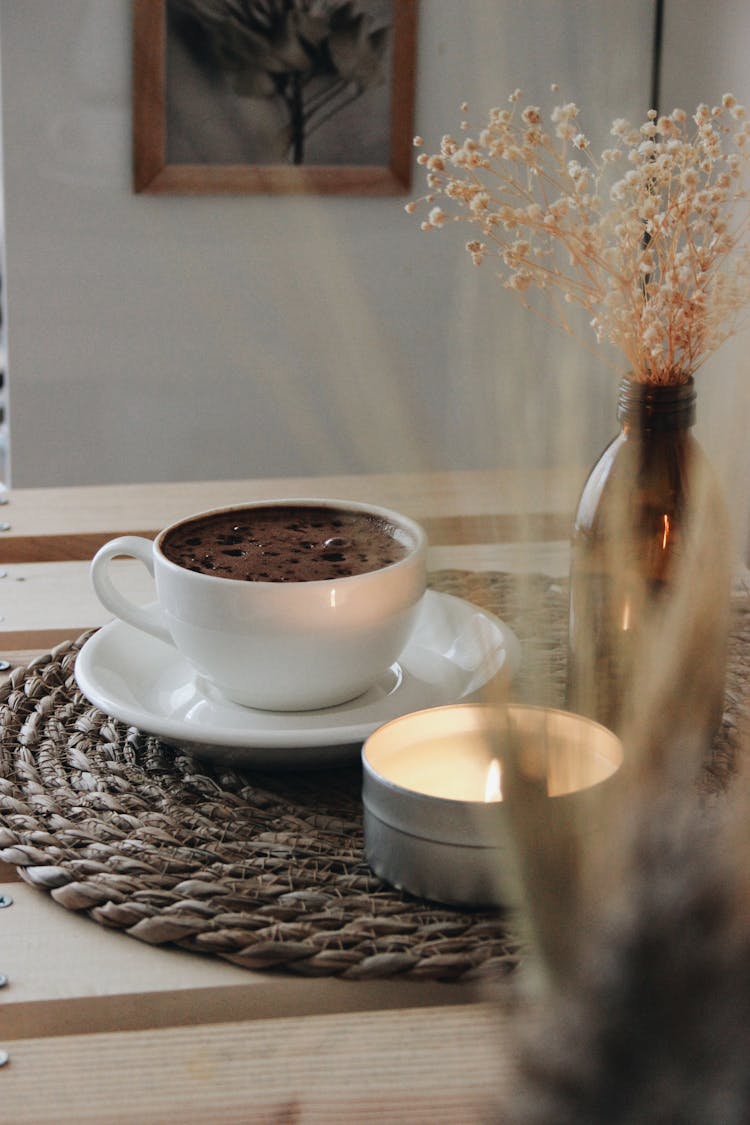 Coffee Cup And Candle On Table