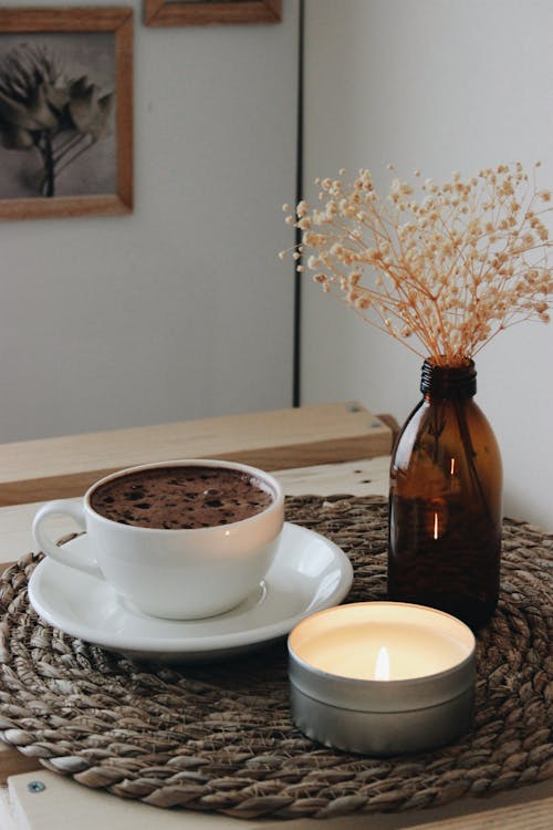 Free Cup of Coffee and Candle on Table Stock Photo