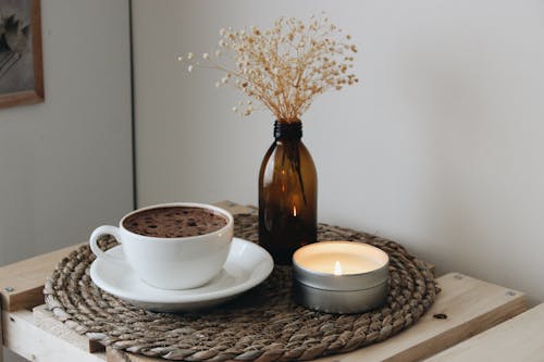 Free Cup of Coffee and Candle on Table Stock Photo