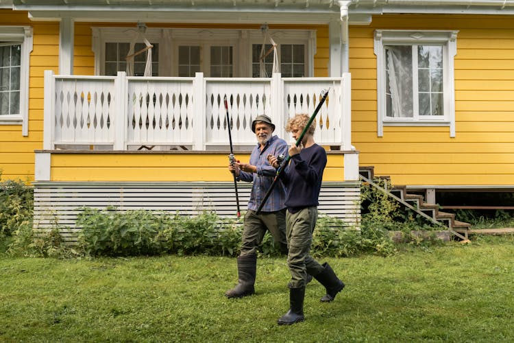 Grandfather And Grandson Going Fishing