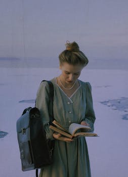 A young woman in vintage attire reading a book outdoors during winter in Moscow.