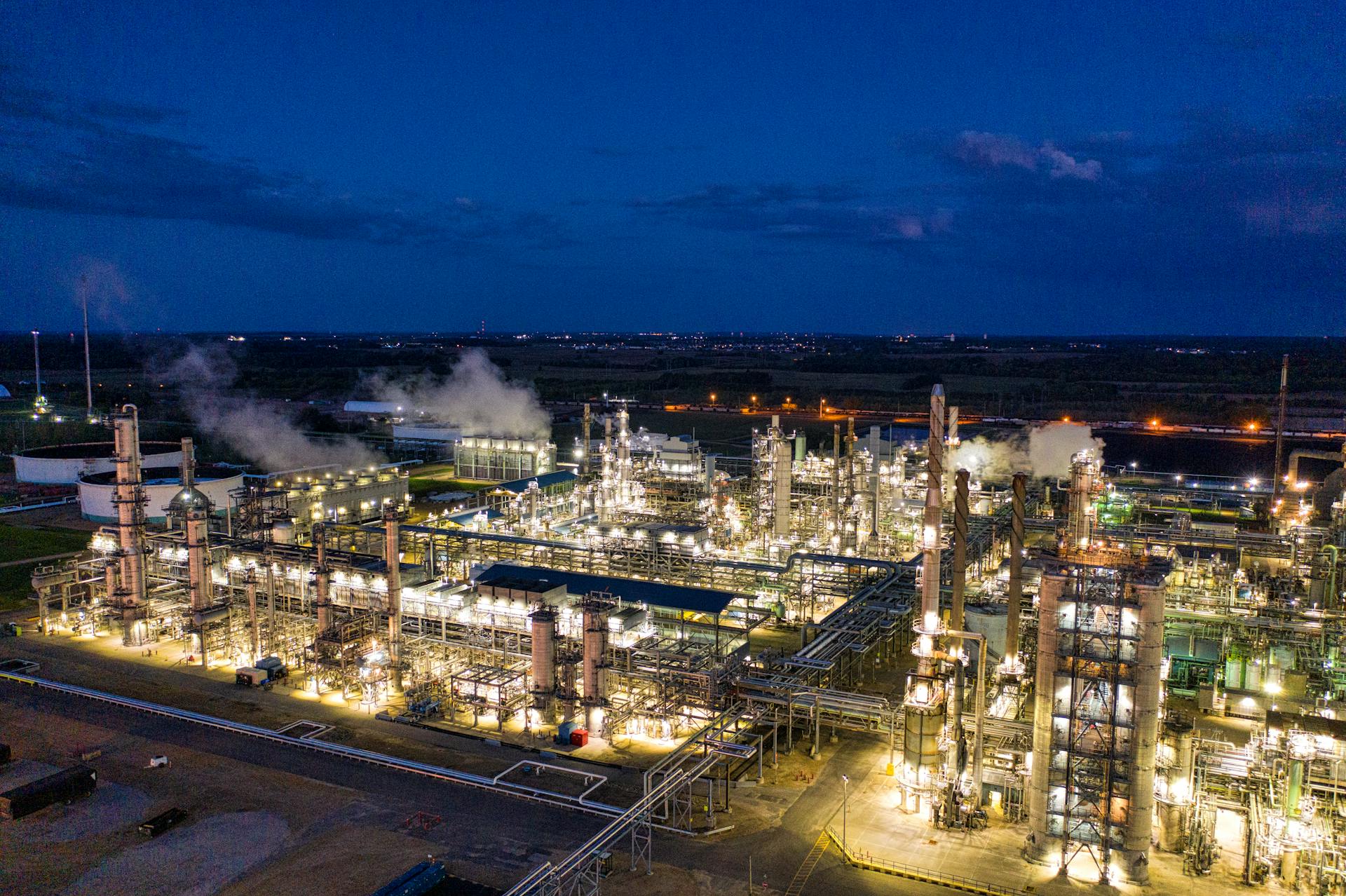 A stunning night aerial shot of a well-lit oil refinery in Rosemount, Minnesota, showcasing its industrial beauty.