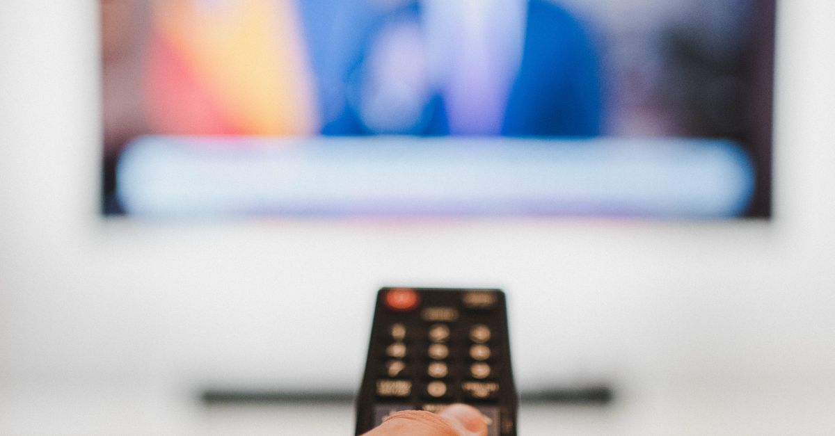 persons holding a red and black remote controllers ·... Person Holding Black Remote Control · Free Stock Photo