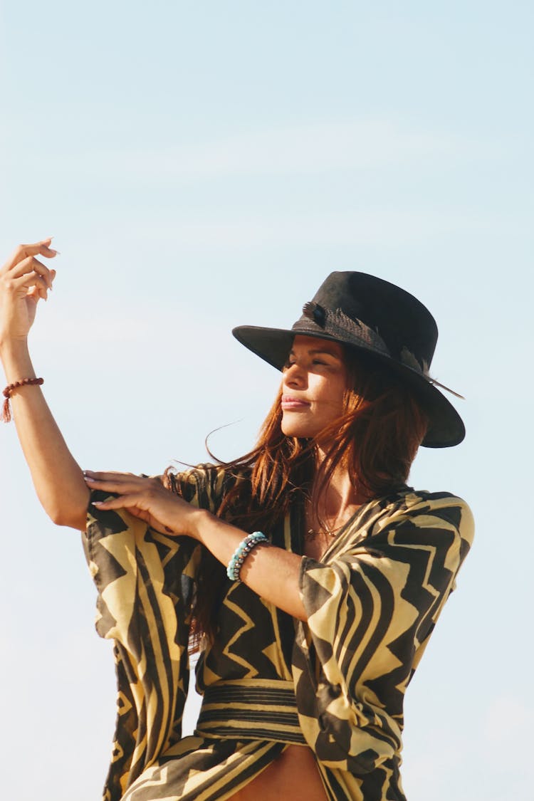 Woman In Black Hat Looking At Sun