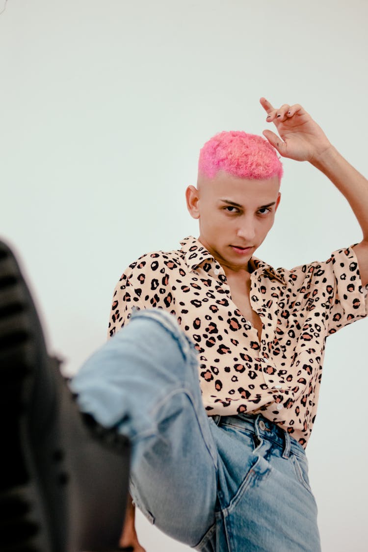 A Man In Leopard Print Shirt And Denim Jeans With Pink Hair