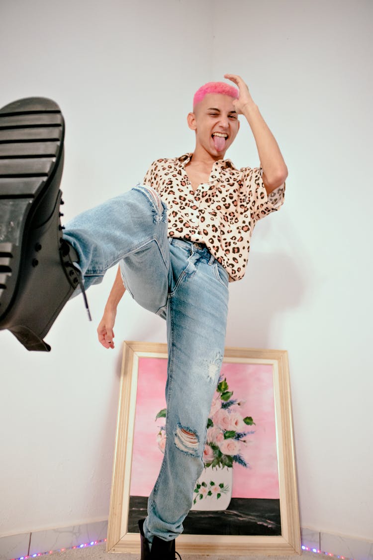 A Low Angle Shot Of A Man In Denim Jeans In Kicking Position