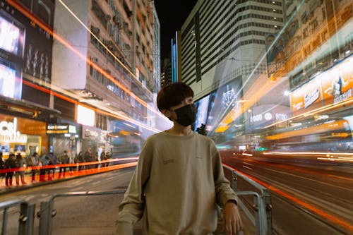 A Person Leaning on a Metal Gate