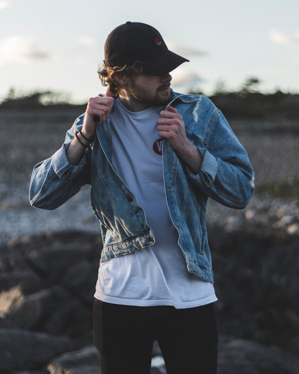 Man in Blue Denim Jacket, White Crew-neck Shirt and Black Pants