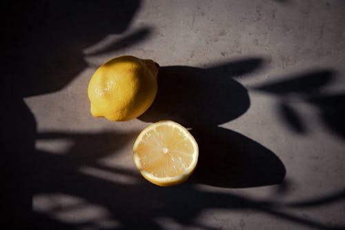 Free A Yellow Lemon Fruits on a Concrete Surface Stock Photo