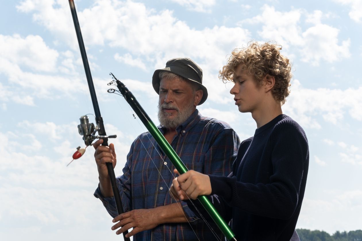 Grandfather and grandson fishing together