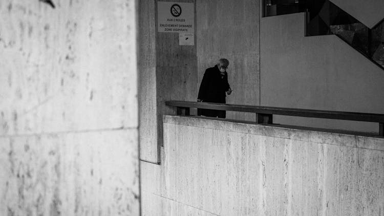 Man Walking In Stone Building Indoors