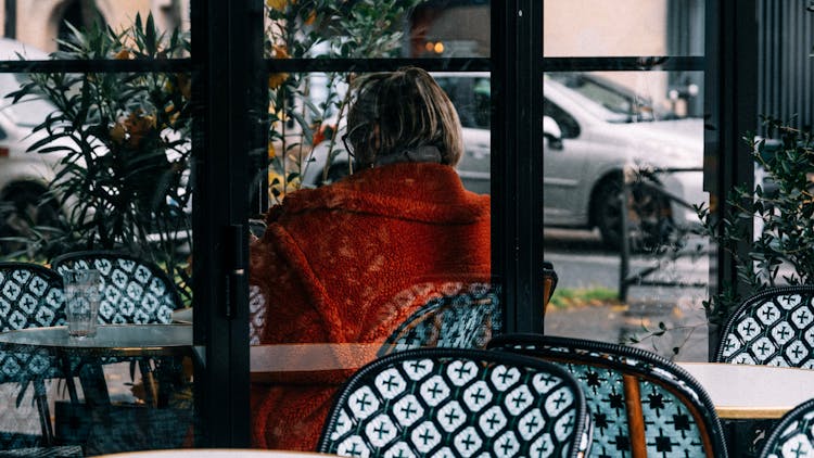 Woman Sitting In A Restaurant 