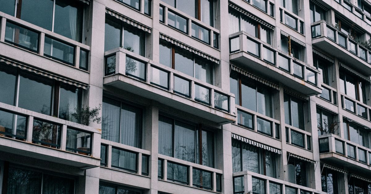 Close-up view of a contemporary building exterior with glass windows and balconies.