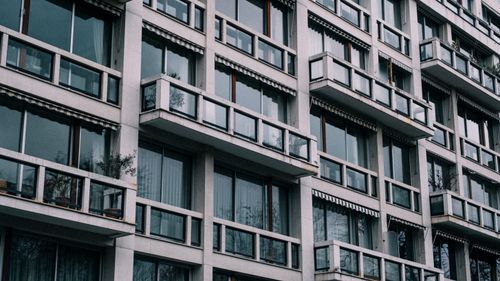 Free Close-up view of a contemporary building exterior with glass windows and balconies. Stock Photo