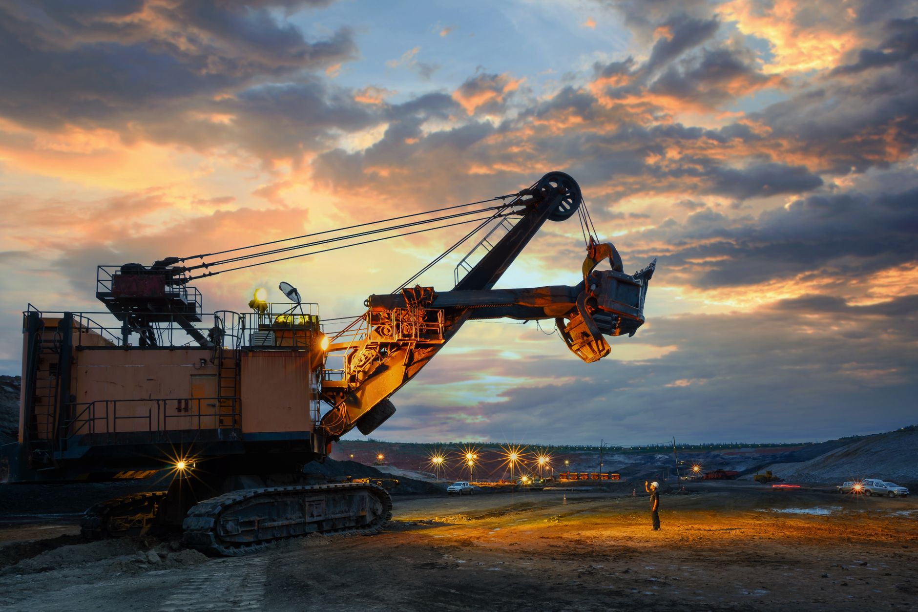 Excavator working at sunset