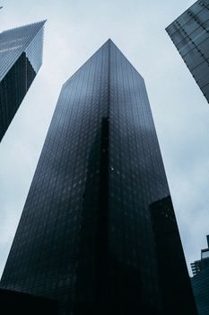 Dramatic cityscape of towering skyscrapers against a moody sky.
