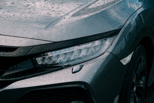 Rain on the Headlight and Hood of a Car