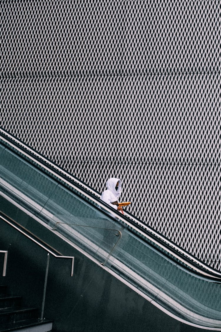 Person Going Down On An Escalator