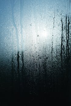 Close-up of water condensation on glass as sunlight filters through, creating a serene and calming ambiance.