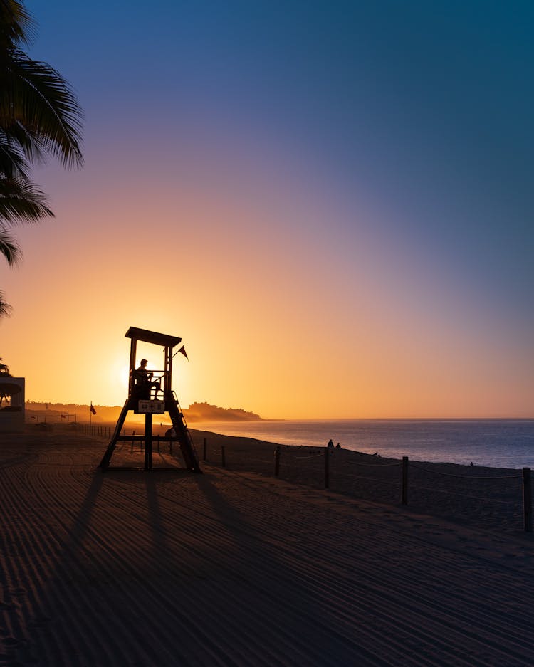 Lifeguard On Beach During Sunrise