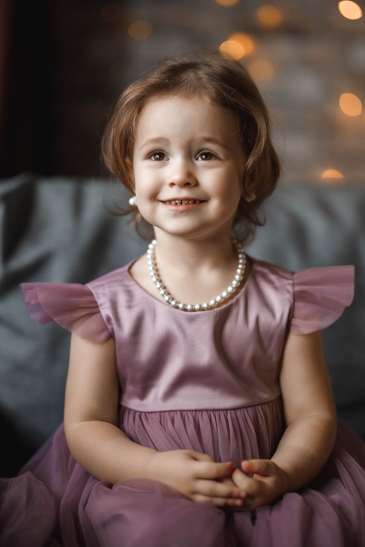 Portrait Of Girl Dressed In Elegant Clothes Wearing Pearl Necklace