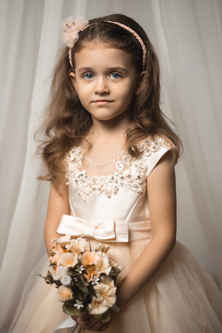 Portrait Of Flower Girl Holding Bouquet