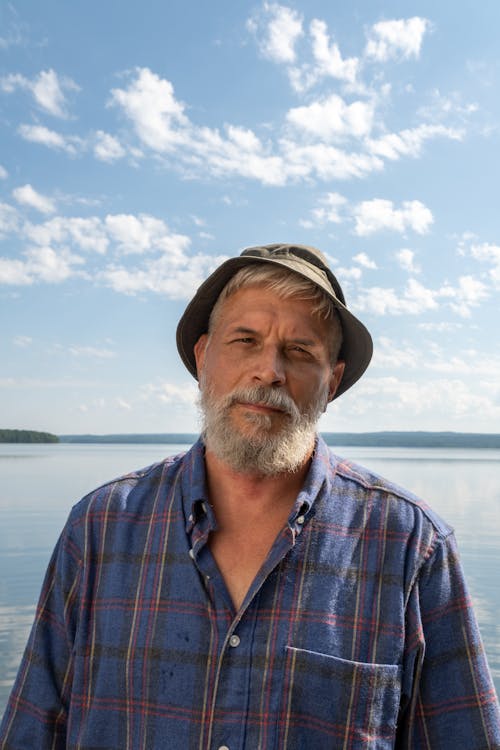 Elderly Man Standing on Pier 