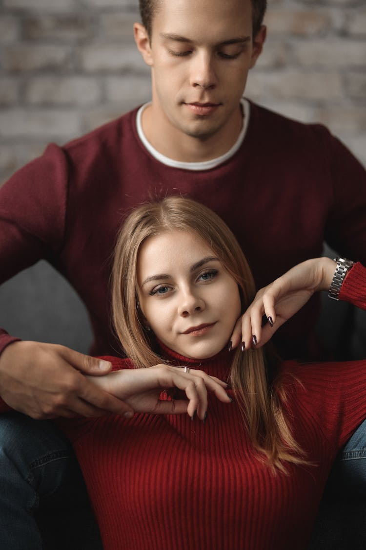 Man Standing Behind Woman And Holding Her Hands Raised