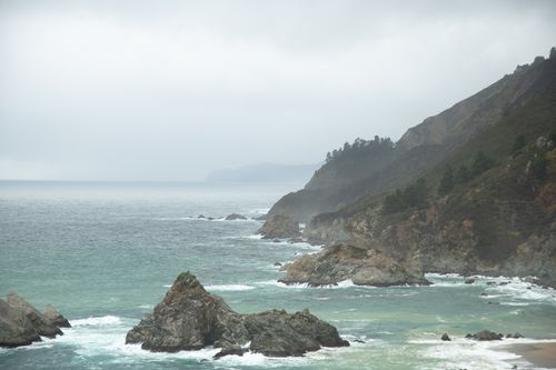 Free Moody coastline with rocky formations and crashing waves near California's shoreline. Stock Photo