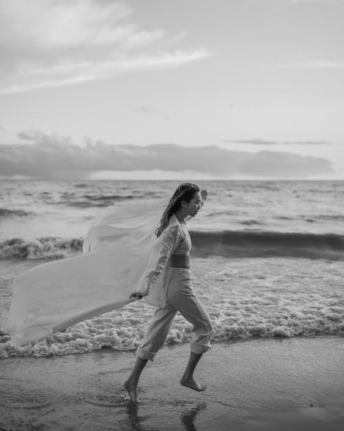 Woman Walking Along Seaside 