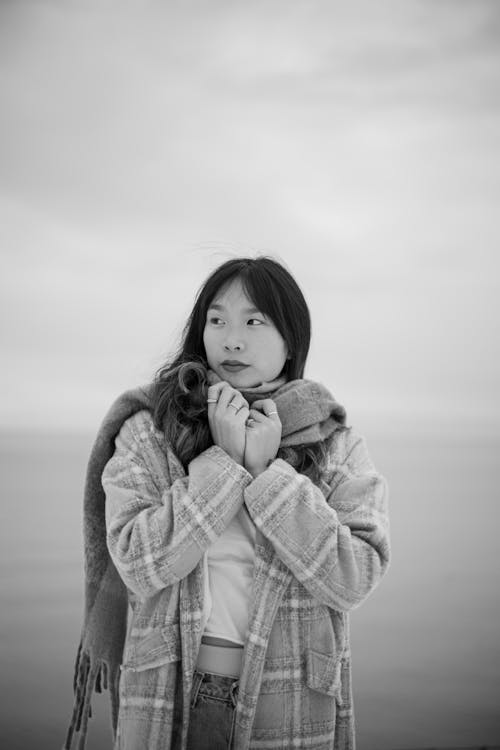 Woman in Scarf and Coat Looking Around in Black and White