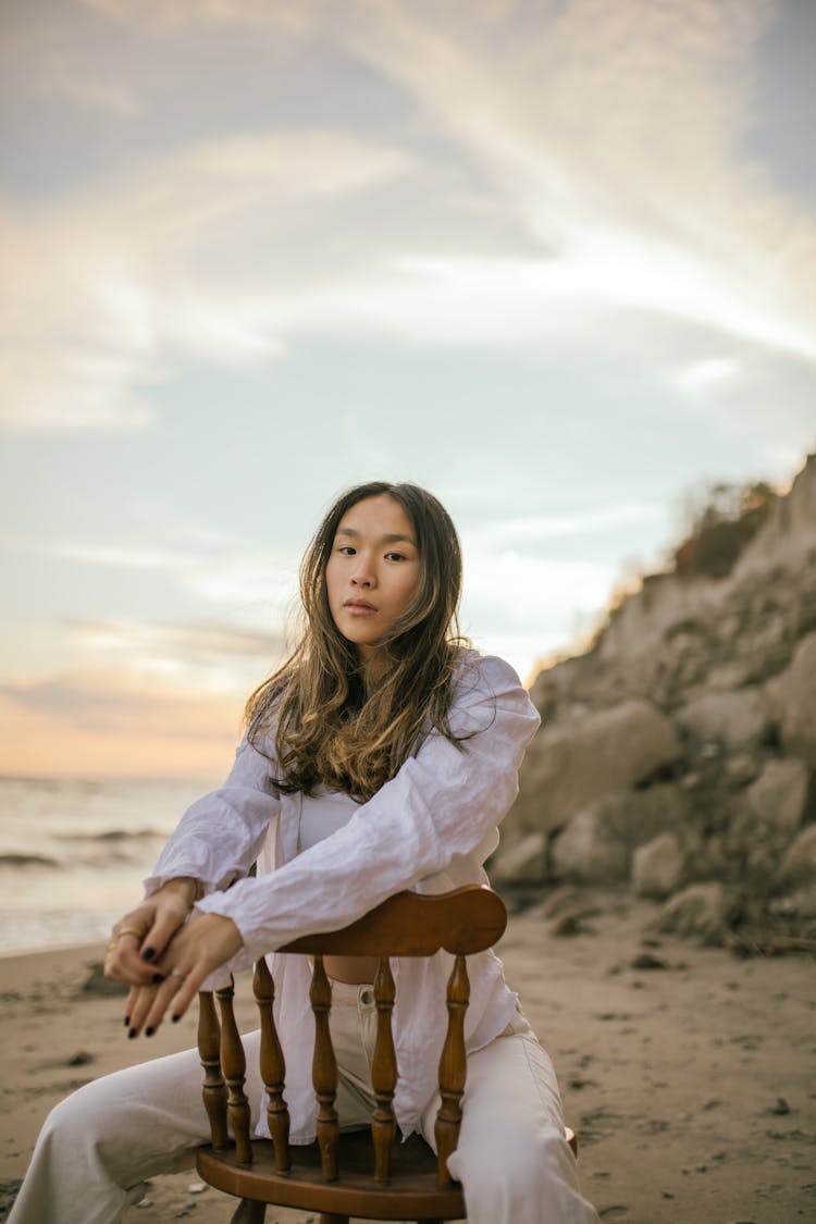 Woman On Beach Sitting On Chair