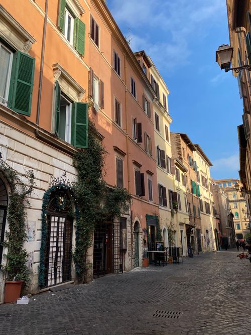 Free A picturesque old town street with colorful buildings and cobblestone pavement under a clear blue sky. Stock Photo