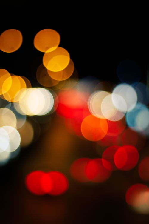 Free A vivid display of blurred colorful lights creating a bokeh effect at night. Stock Photo