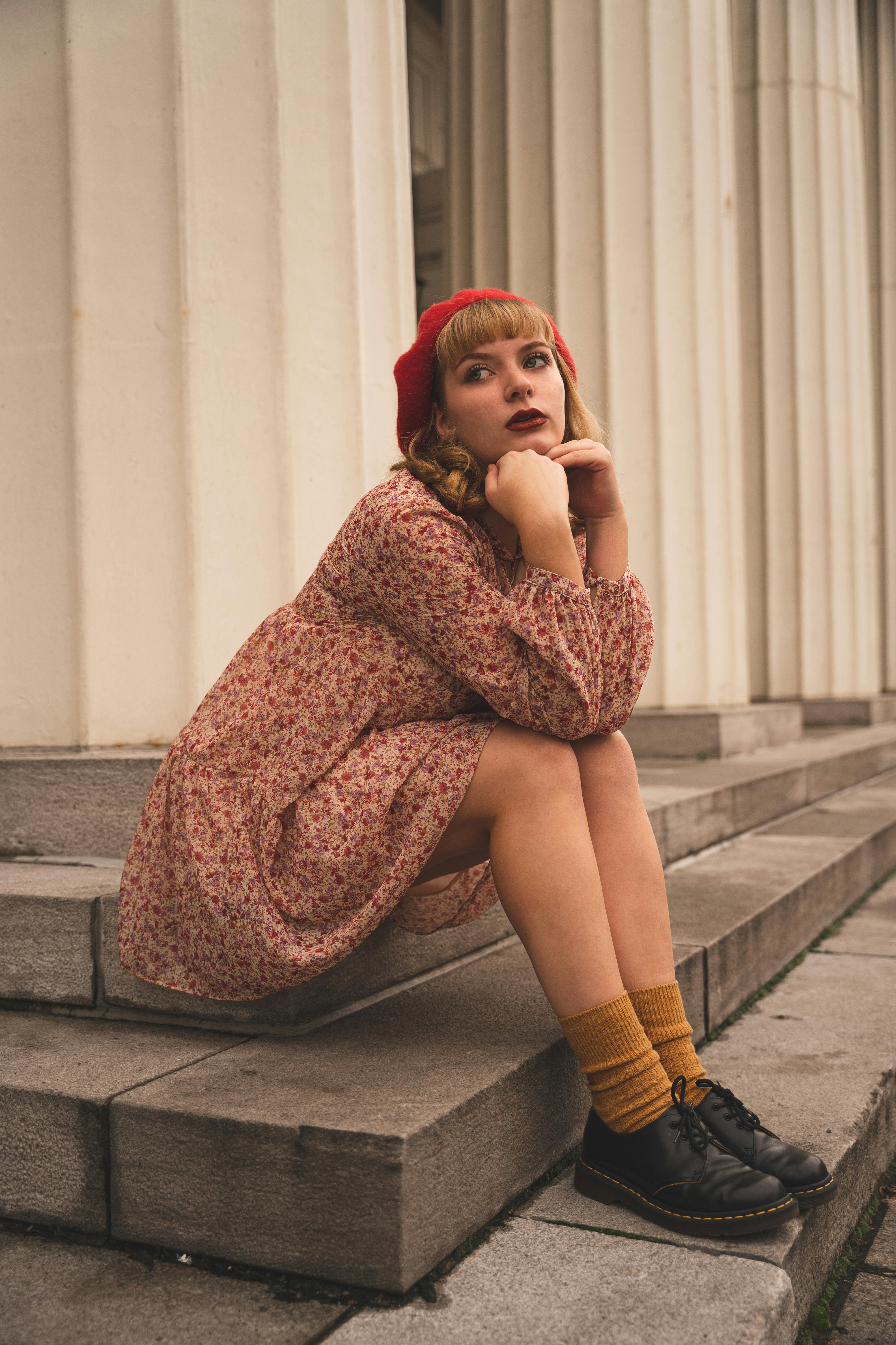 Young Woman in Vintage Clothing Sitting on Steps · Free Stock Photo