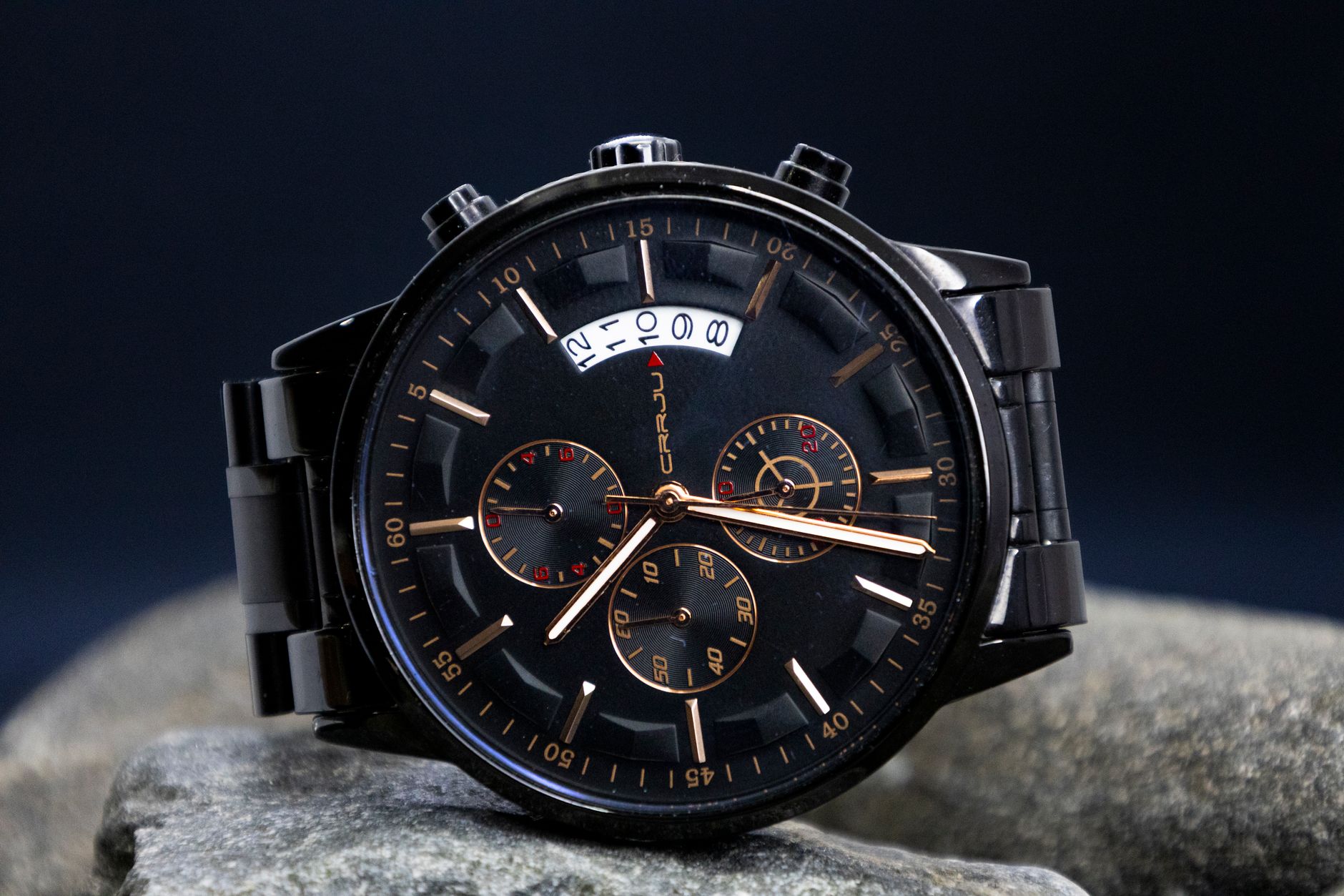 Close-up of a stylish black chronograph wristwatch showcasing its intricate dial design.