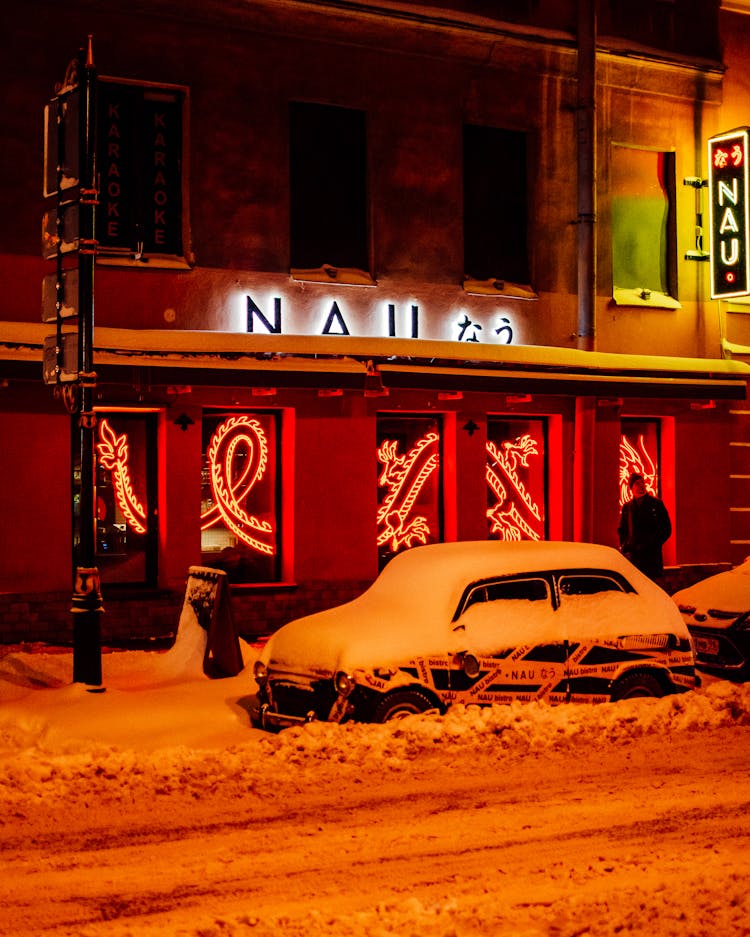 A Parked Car Covered In Snow