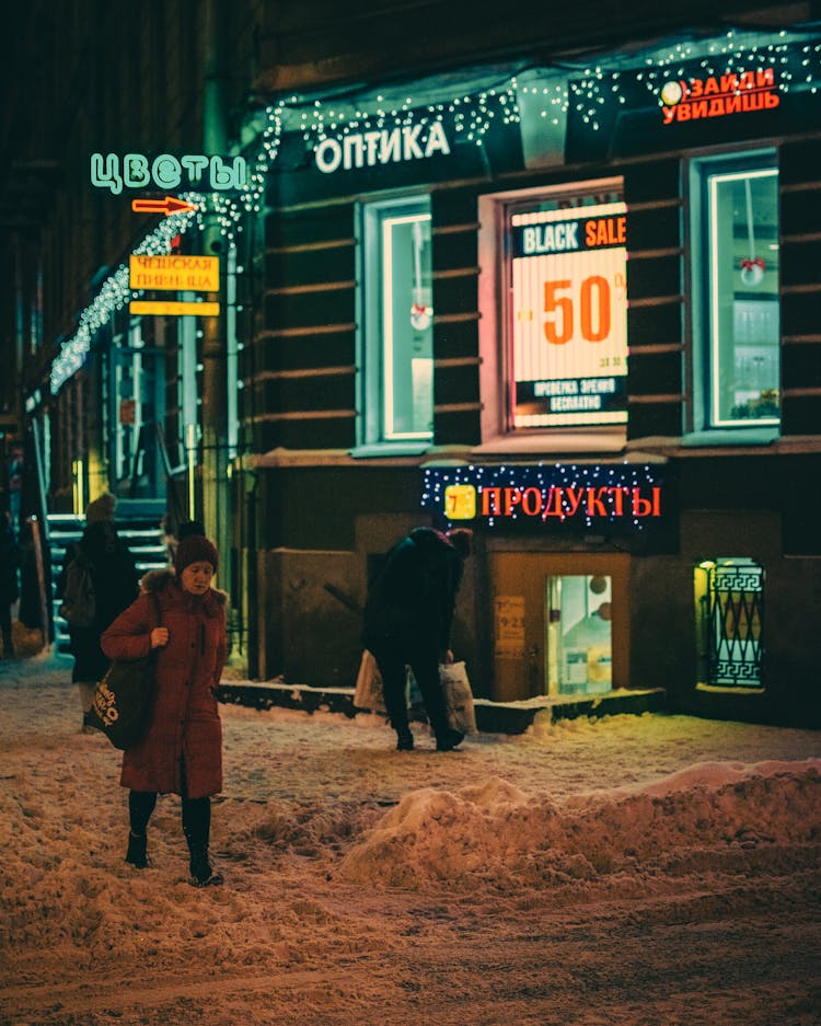 People Walking In A Snowy Sidewalk