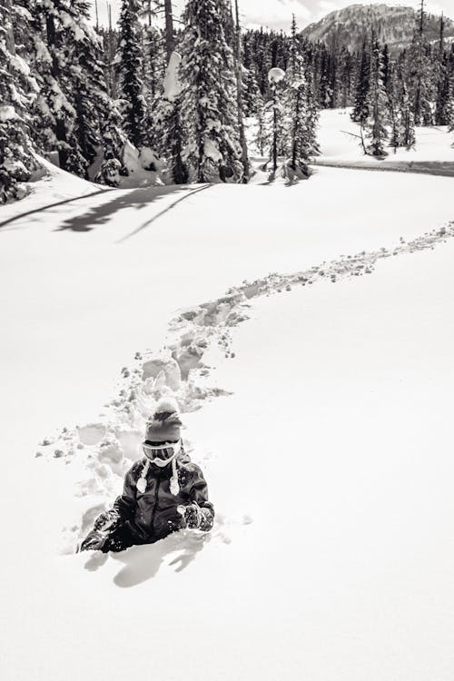 A Grayscale of a Woman on a Snow Covered Field