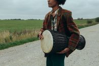Man in Red and Black Plaid Dress Shirt Playing Drum
