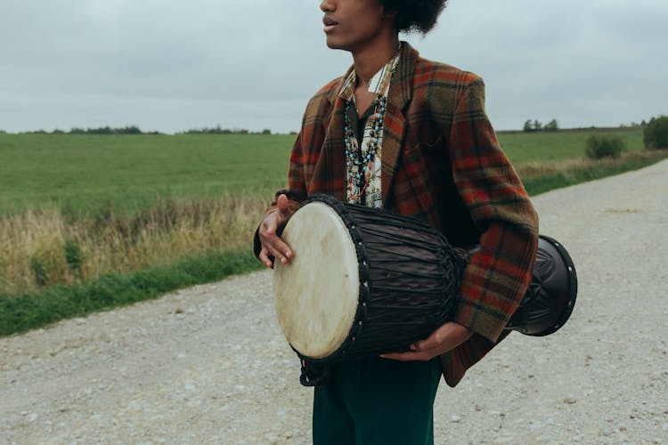 Man Carrying A Bongo Drum