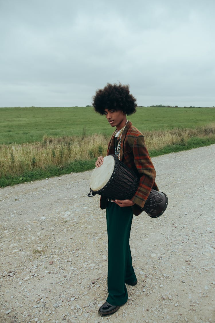 Woman In Plaid Blazer Holding A Drum