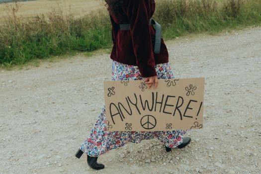 Woman Holding a Poster While Walking