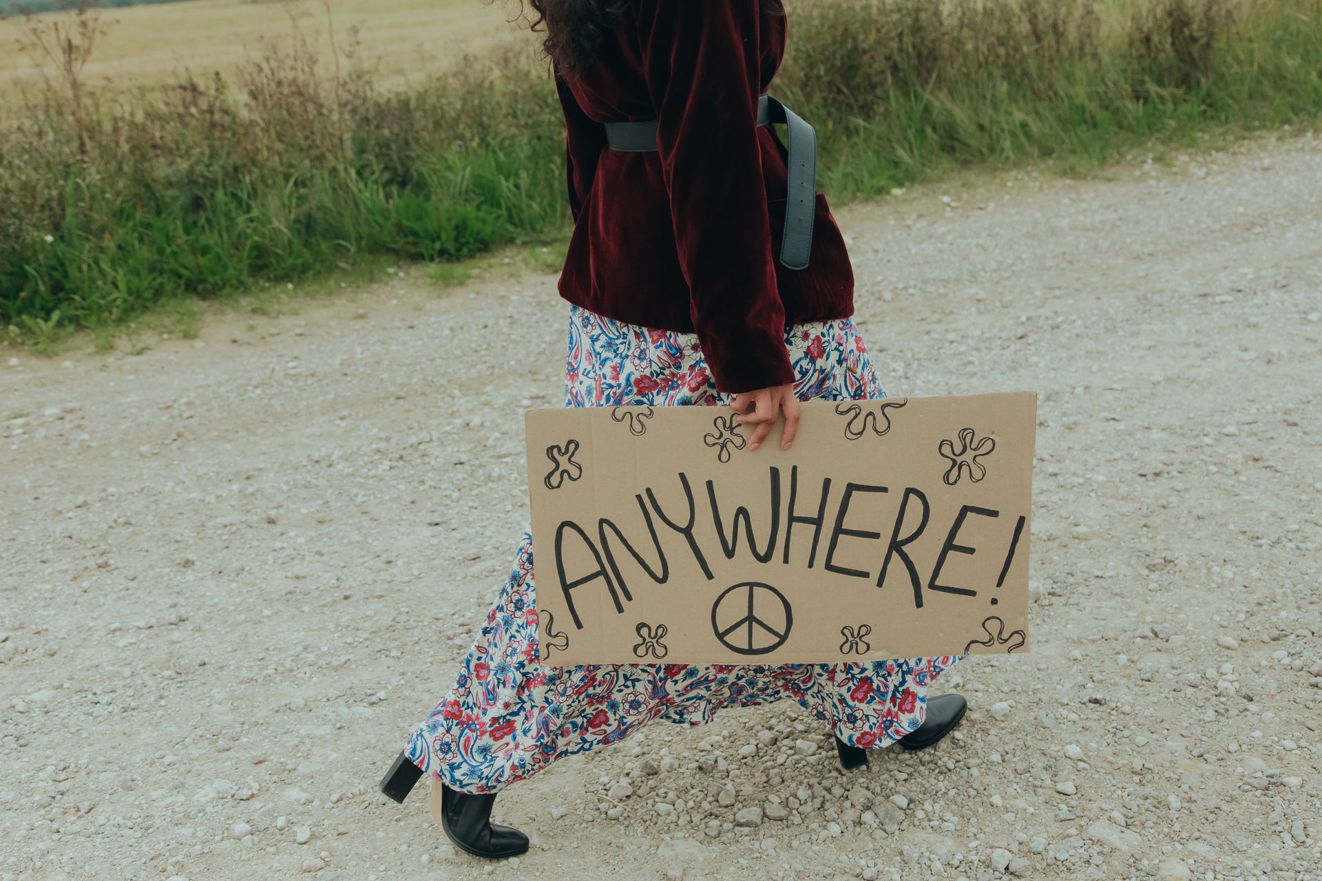 Woman Holding a Poster While Walking