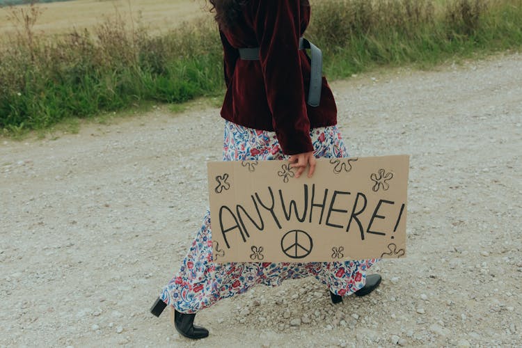 Woman Holding A Poster While Walking