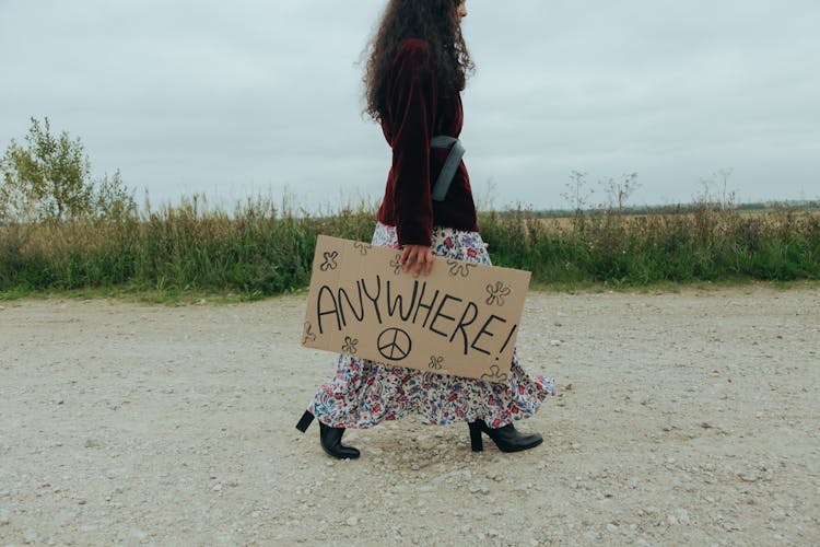 Woman Holding A Poster Walking