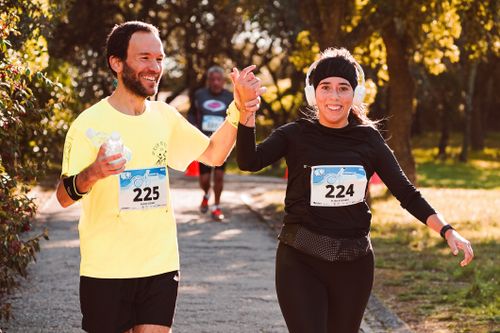 Free Happy runners celebrate finishing a race outdoors, showcasing team spirit and fitness. Stock Photo